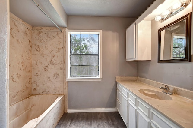 full bathroom with vanity, baseboards, and wood finished floors