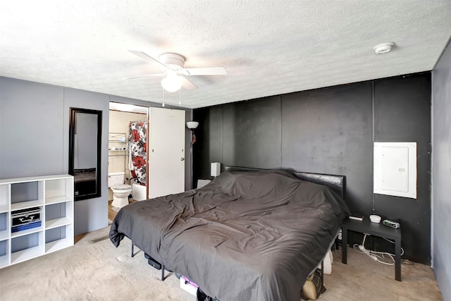 bedroom featuring a ceiling fan, electric panel, carpet, and a textured ceiling