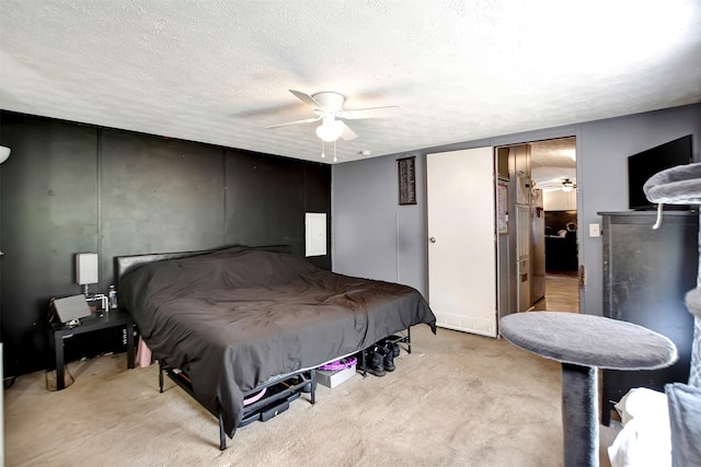 bedroom with a textured ceiling, a ceiling fan, and carpet floors