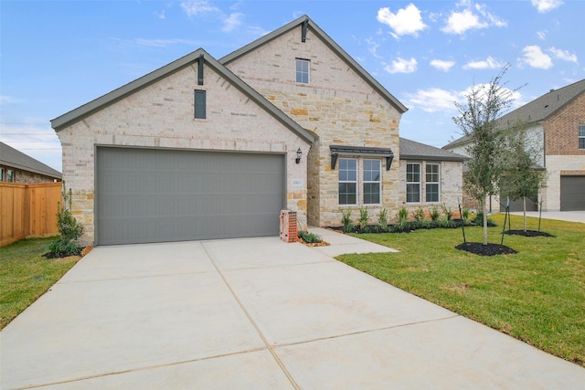 view of front of property with a front lawn, fence, concrete driveway, stone siding, and an attached garage