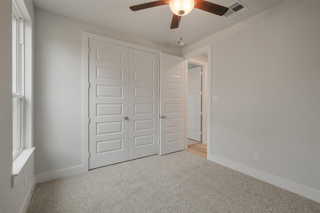 unfurnished bedroom featuring carpet flooring, baseboards, and a closet