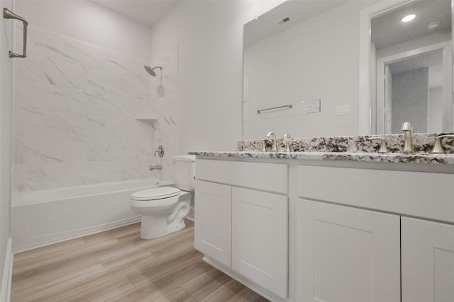 full bathroom featuring wood finished floors, visible vents,  shower combination, double vanity, and toilet