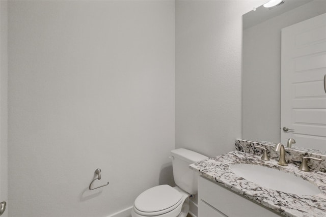 bathroom with visible vents, baseboards, toilet, and vanity