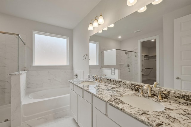 bathroom featuring visible vents, a stall shower, a sink, a spacious closet, and marble finish floor