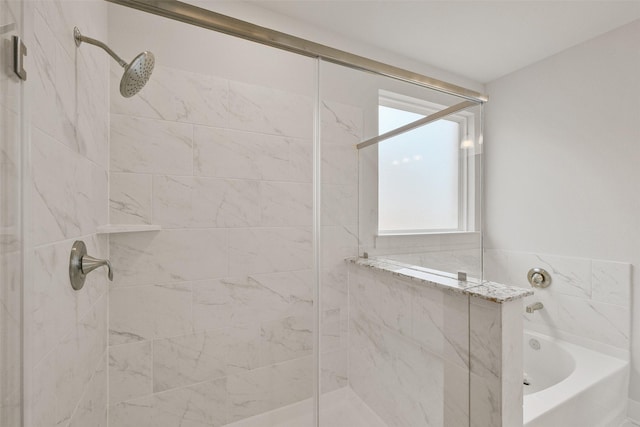 bathroom featuring tiled shower and a garden tub