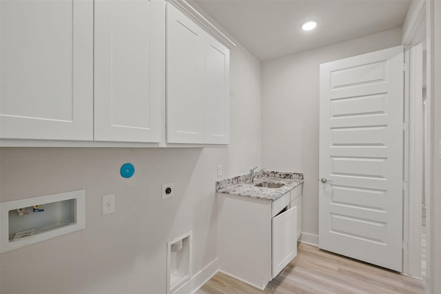 laundry room with hookup for an electric dryer, cabinet space, a sink, washer hookup, and light wood-style floors