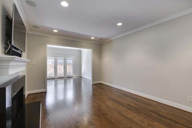 unfurnished living room with dark wood-style floors, recessed lighting, a fireplace, crown molding, and baseboards