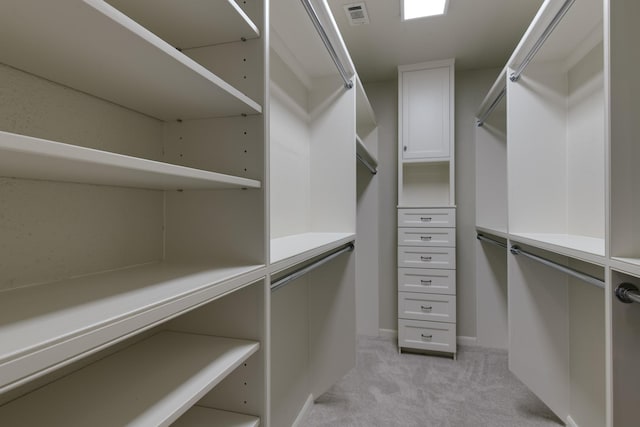 spacious closet with light colored carpet and visible vents