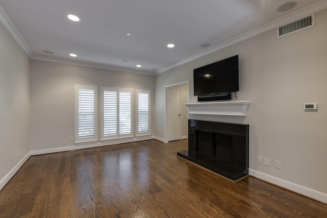 unfurnished living room with visible vents, ornamental molding, a fireplace, and dark wood-style flooring