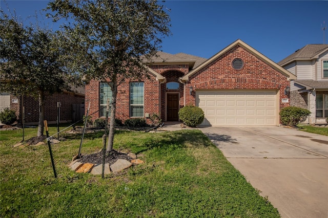 view of front of house with a front lawn, an attached garage, brick siding, and concrete driveway