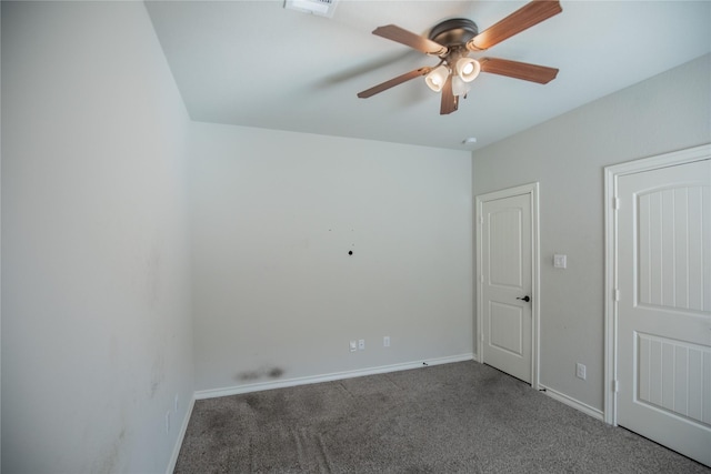 spare room with visible vents, a ceiling fan, baseboards, and carpet floors