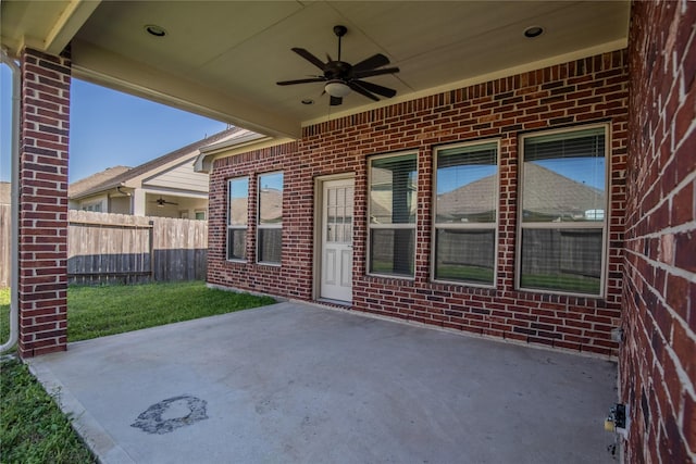 view of patio featuring ceiling fan and fence