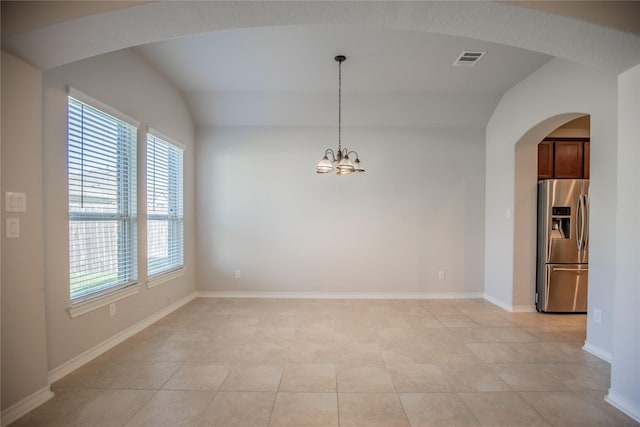 empty room with visible vents, baseboards, light tile patterned floors, an inviting chandelier, and arched walkways