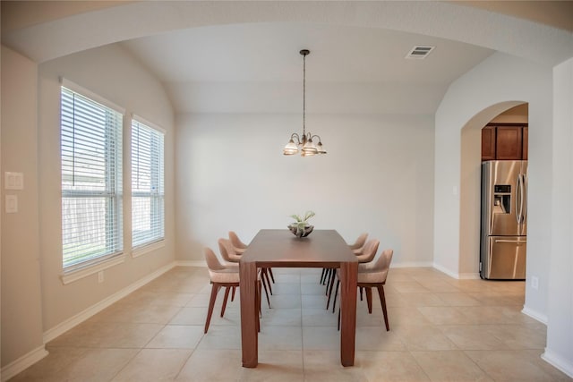 dining room featuring visible vents, arched walkways, an inviting chandelier, light tile patterned floors, and baseboards