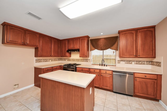 kitchen featuring visible vents, a sink, light countertops, under cabinet range hood, and appliances with stainless steel finishes