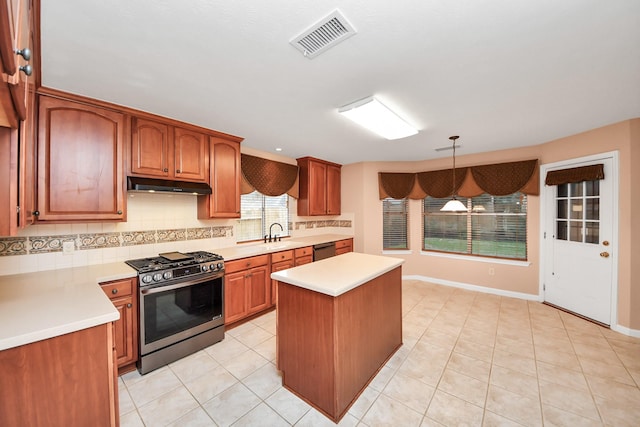 kitchen with visible vents, under cabinet range hood, dishwasher, stainless steel gas range, and a sink