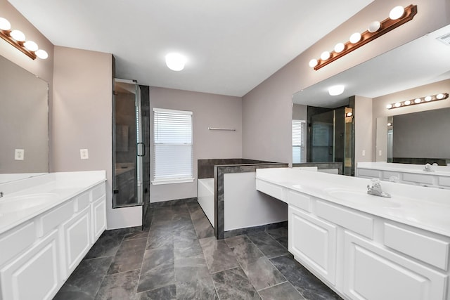 bathroom featuring a wealth of natural light, a shower stall, and a sink