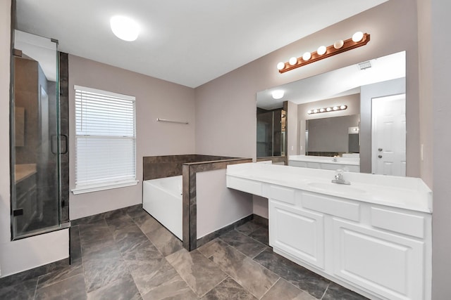 full bath featuring vanity, a garden tub, and a stall shower