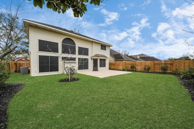 rear view of house featuring central air condition unit, a lawn, a fenced backyard, and a patio area