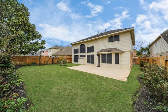 rear view of house featuring a patio area, a lawn, and a fenced backyard