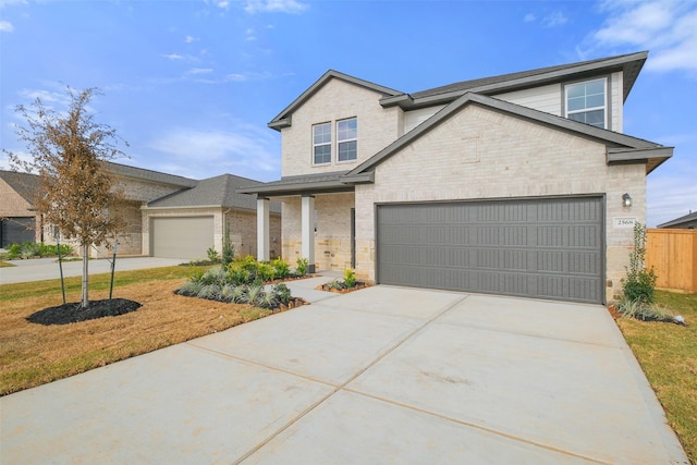 view of front of house featuring brick siding, concrete driveway, an attached garage, and fence