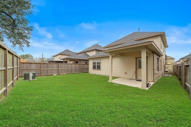 back of property featuring a fenced backyard, a patio area, and a yard