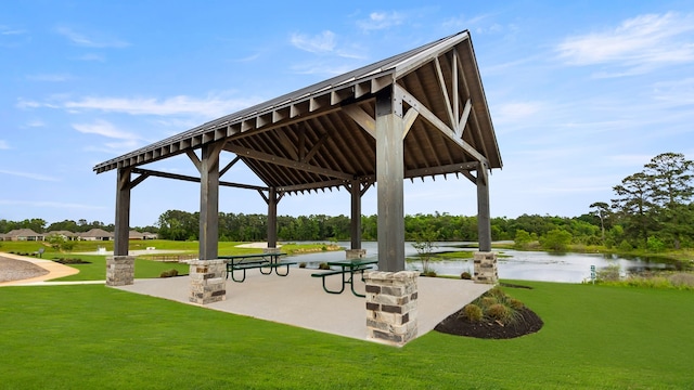 view of community featuring a gazebo, a yard, and a water view