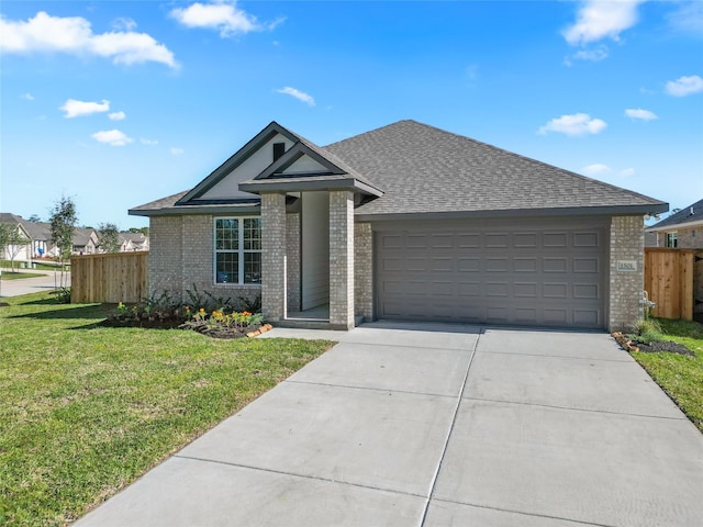 view of front of house with fence, concrete driveway, a front yard, a garage, and brick siding