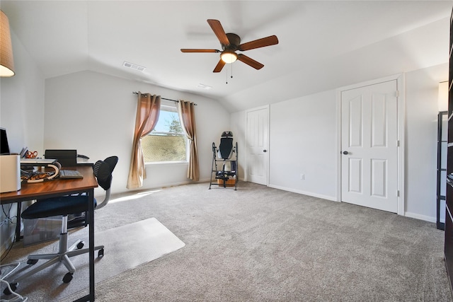 carpeted home office featuring a ceiling fan, lofted ceiling, baseboards, and visible vents