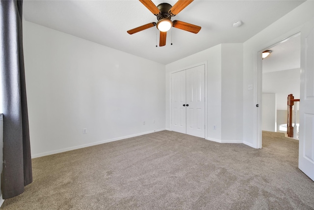 unfurnished bedroom with a closet, a ceiling fan, baseboards, and carpet floors