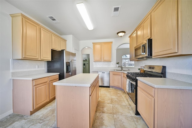 kitchen with visible vents, light brown cabinets, stainless steel appliances, and light countertops