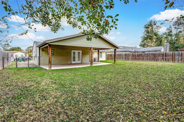 back of property featuring a patio area, a yard, french doors, and a fenced backyard