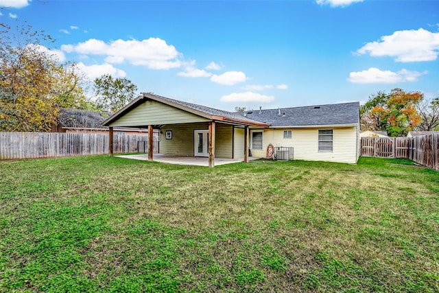 back of property with a yard, a patio, a fenced backyard, and central air condition unit