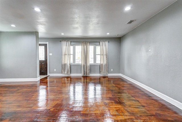 unfurnished room featuring recessed lighting, visible vents, baseboards, and wood finished floors