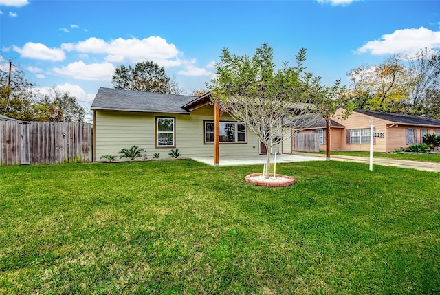 ranch-style house featuring a patio area, driveway, a front yard, and fence