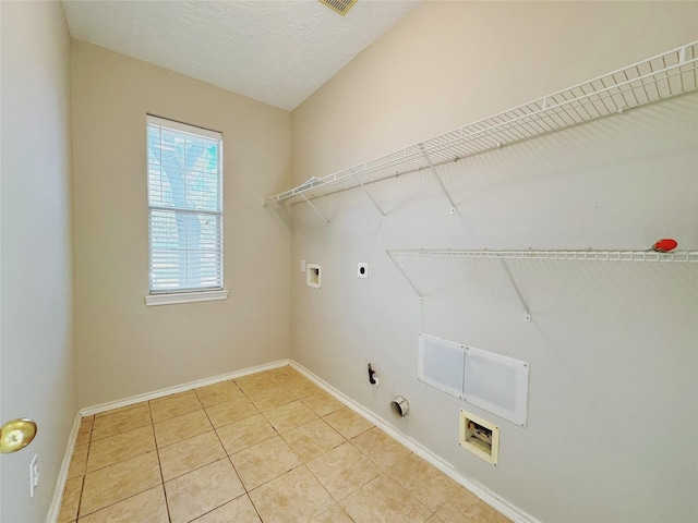 washroom with hookup for a washing machine, laundry area, light tile patterned flooring, electric dryer hookup, and hookup for a gas dryer