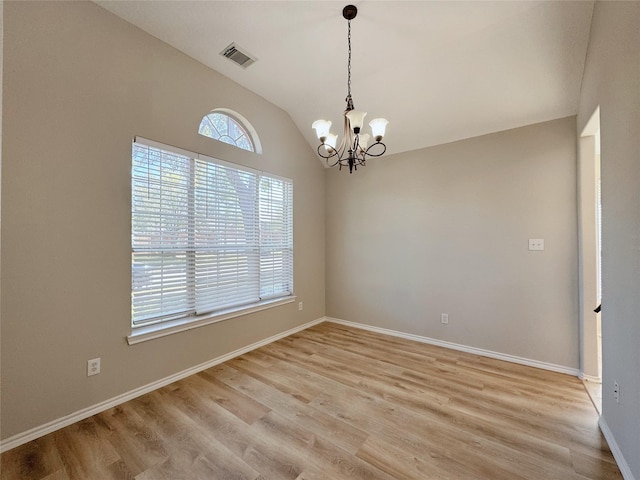 unfurnished room with baseboards, visible vents, light wood finished floors, lofted ceiling, and a notable chandelier