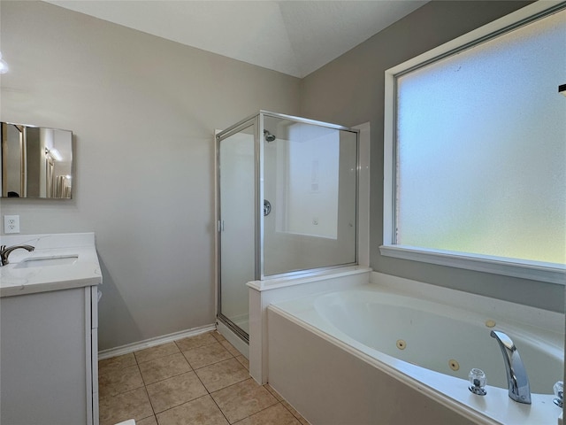 bathroom featuring tile patterned floors, a stall shower, a jetted tub, baseboards, and vanity