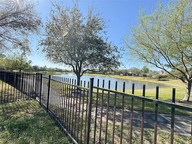 exterior space featuring a water view and fence