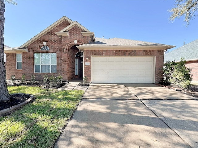 ranch-style house featuring an attached garage, brick siding, and driveway