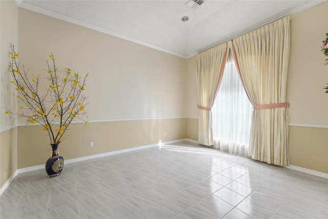 spare room with light tile patterned flooring, visible vents, a textured ceiling, and baseboards