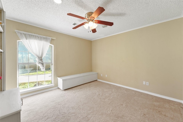 unfurnished room with visible vents, a healthy amount of sunlight, ornamental molding, and carpet floors