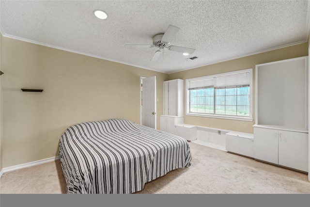 carpeted bedroom with visible vents, ceiling fan, crown molding, and baseboards