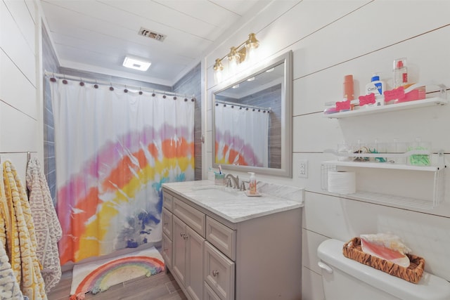 bathroom featuring vanity, wood finished floors, visible vents, curtained shower, and toilet