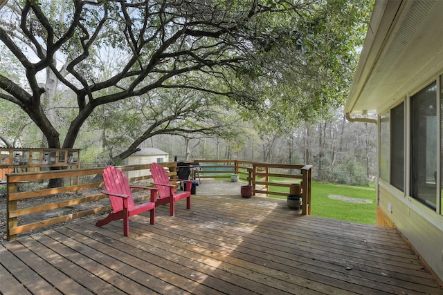 wooden deck featuring a yard