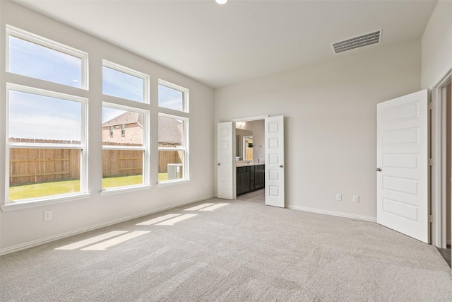 unfurnished bedroom with light carpet and baseboards
