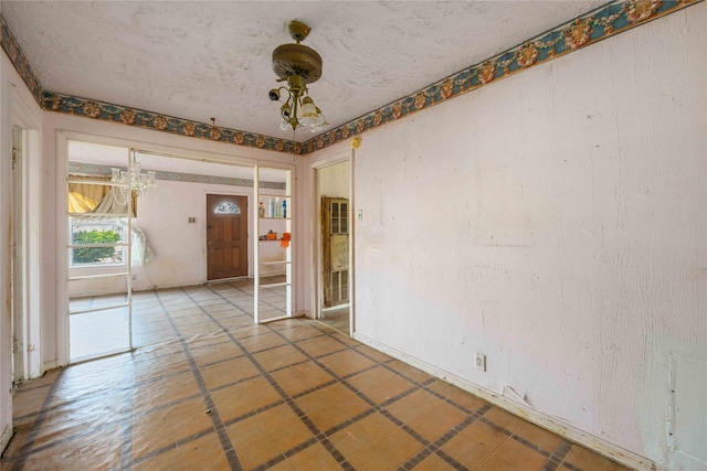 spare room with a chandelier