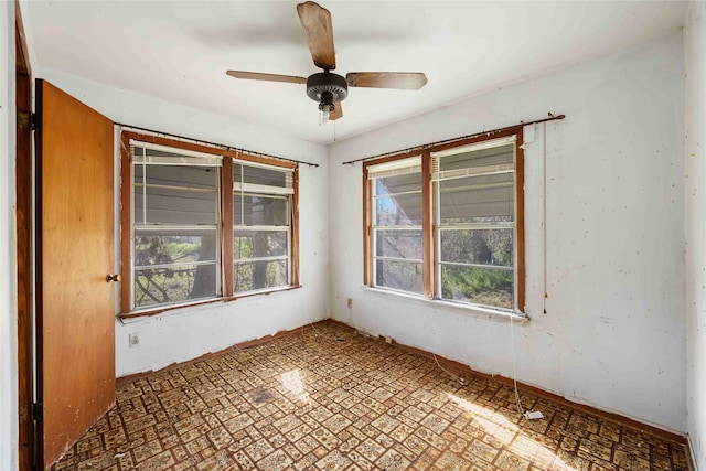 unfurnished room with ceiling fan
