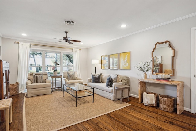 living room featuring visible vents, dark wood-type flooring, and crown molding