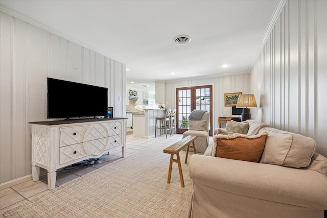 living room featuring ornamental molding, visible vents, and recessed lighting